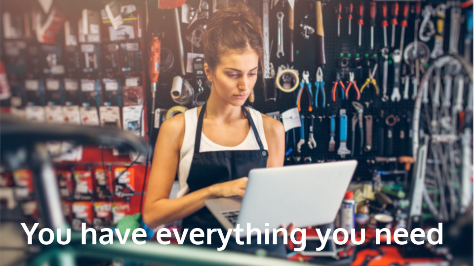 Woman with laptop in mechanic workshop